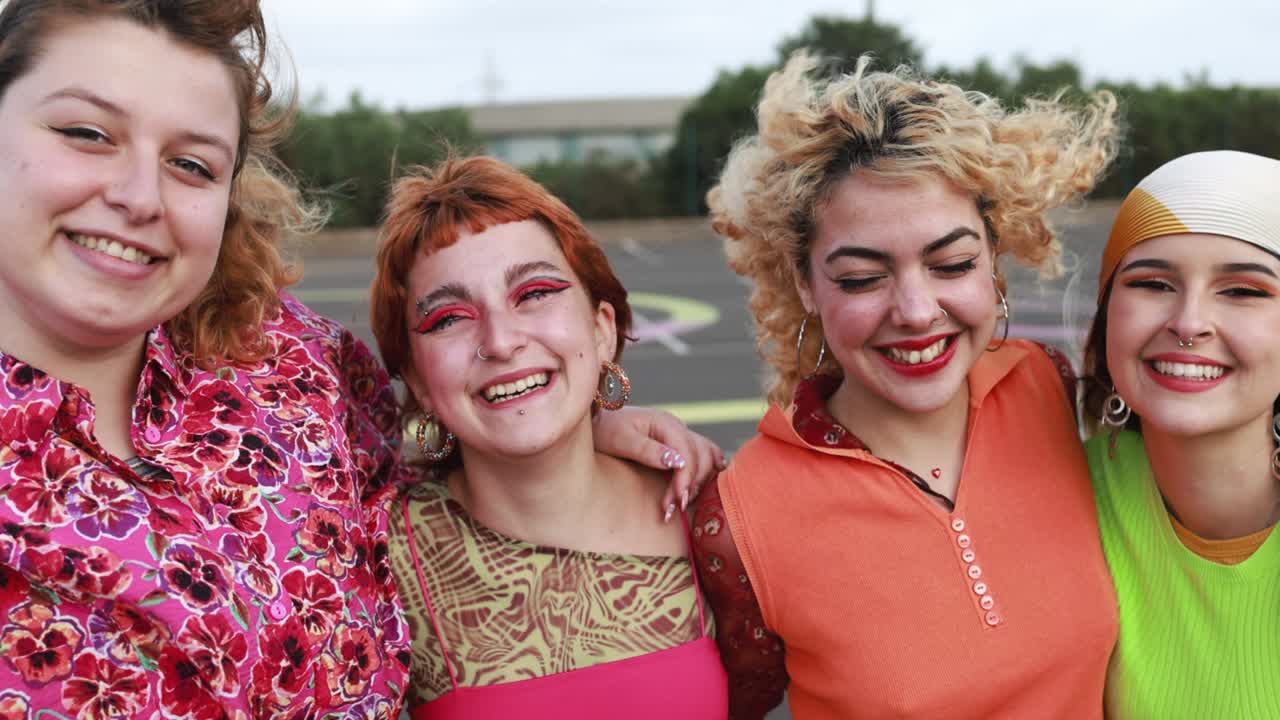 Young diverse female friends having fun outdoor laughing together