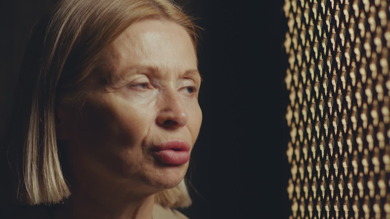 Senior Female Penitent Having Confidential Talk with Priest during Confession