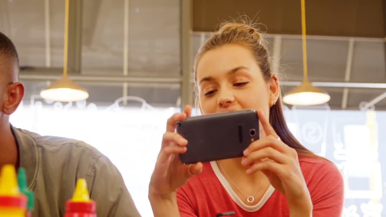 Executives using mobile phone at table 4k