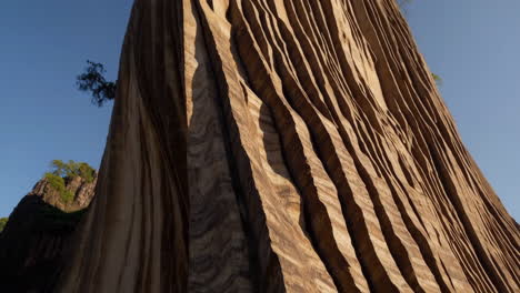 unique layered rock formation against a clear blue sky