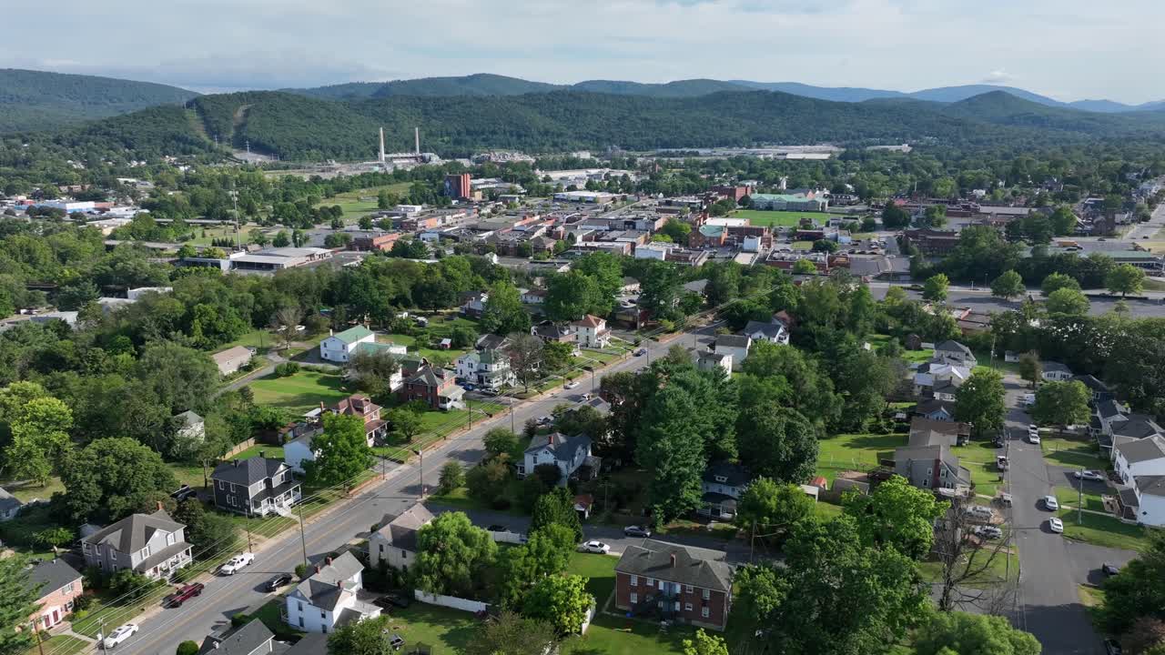 Small American town in summertime with main road , housing area and downtown buildings in background. Aerial wide shot. Sunny day in August. Virginia state, USA