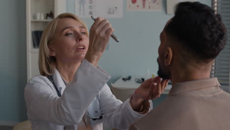 medical exam with a doctor checking the patient's eyes