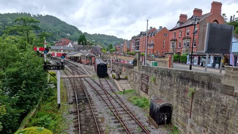 steam train moving through scenic llangollen, wales