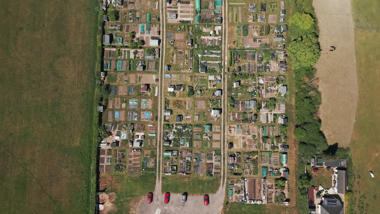 Drone footage of allotments in the UK, drone looking directly down, moving forward