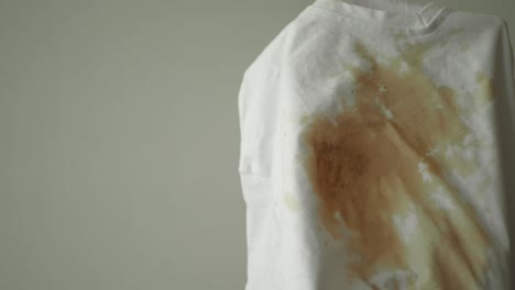 close up of a white shirt with a coffee stain