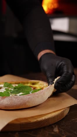 chef preparing a delicious pizza with mint and cheese