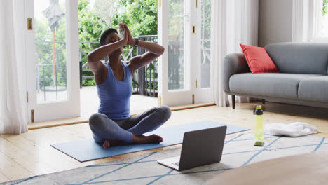 African american woman practicing yoga at home