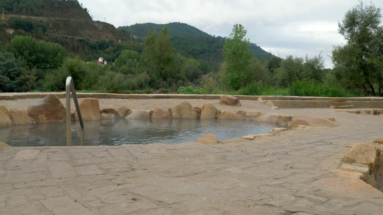 Establishing shot of Muiño da Veiga thermal baths in Ourense, Galicia, Spain