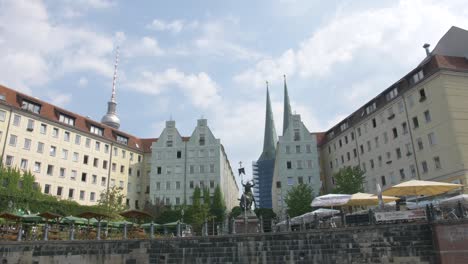 typical views from the river riding a boat tour through berlin city with the television tower and period historical buildings