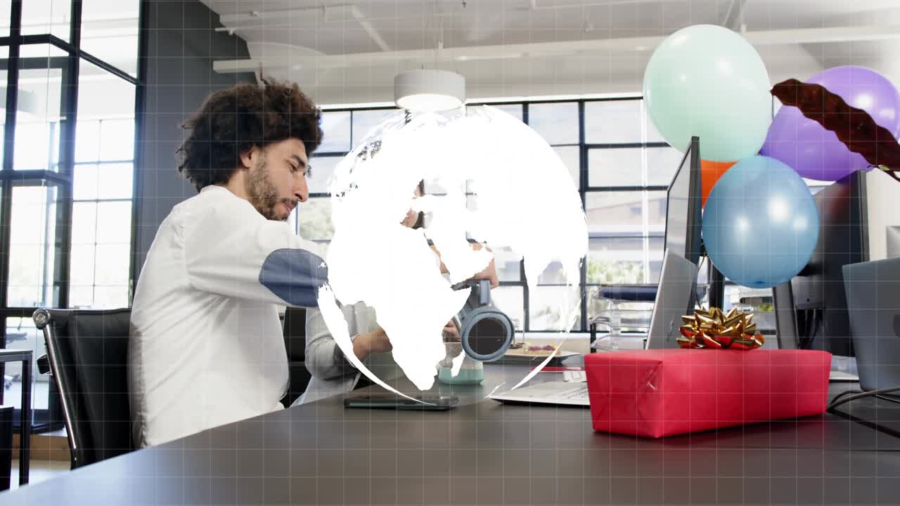 Man grabbing kettle pouring into mug for office party while HUD globe overlaying charts over team