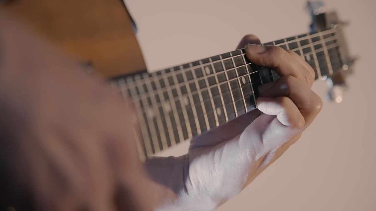 Close-up of a Musician's Hand Playing Chords on an Electric Guitar