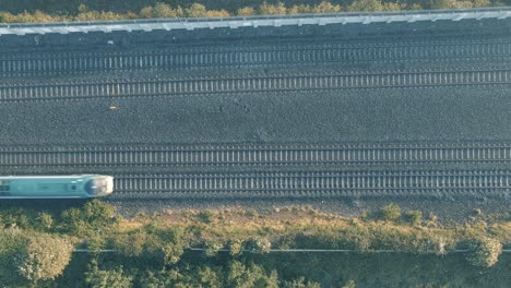 top view of a train passing by on the railway in ireland - aerial