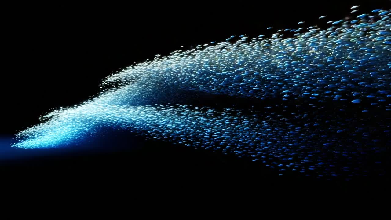 A mesmerizing display of shimmering fish swirling through the deep ocean waters, creating a stunning visual effect with their shimmering movement and vibrant blue light, captivating all who behold it