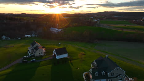New modern large American homes in rural countryside at sunrise. Aerial in Lancaster County Pennsylvania farmland scene.