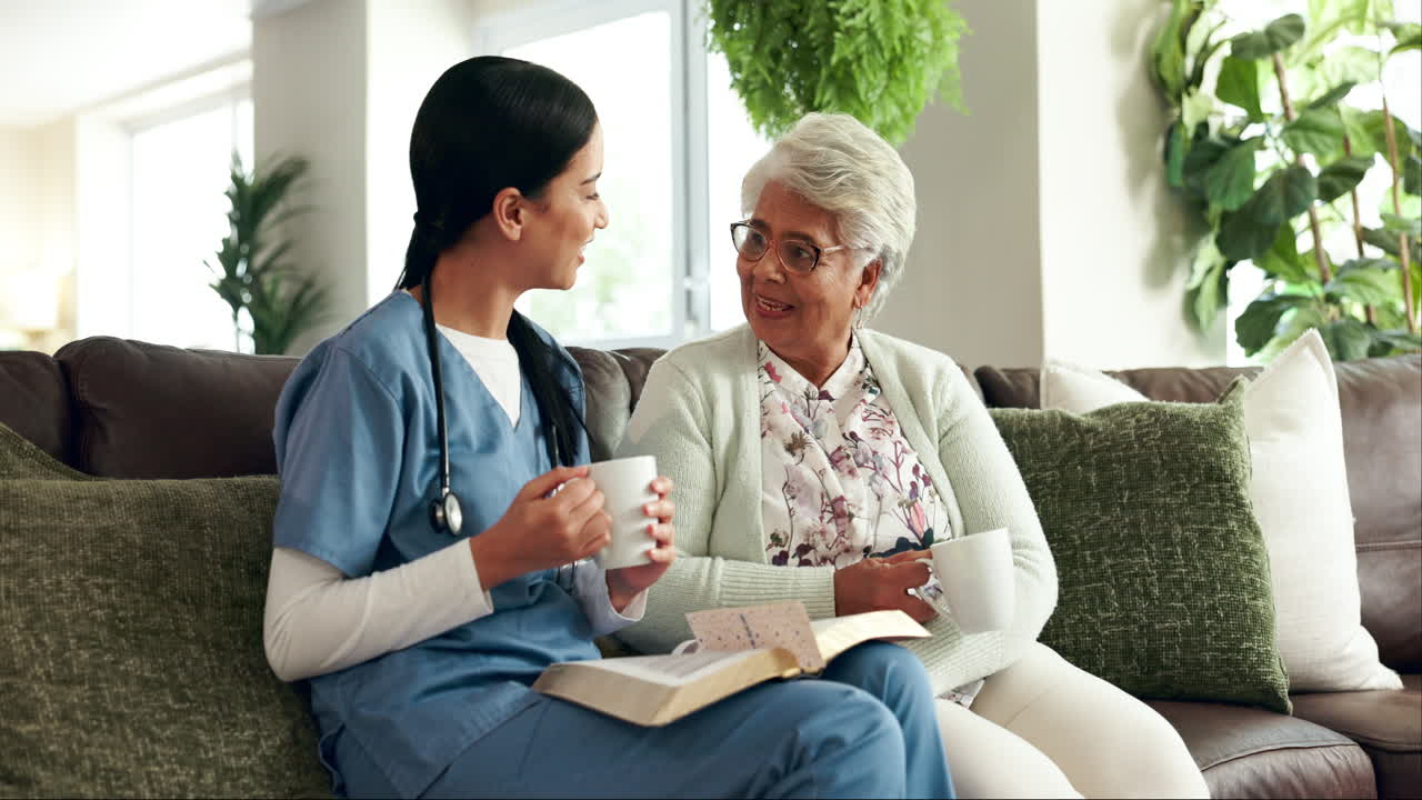 Nurse Reading with Senior Woman at Home