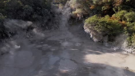lento ascenso aéreo sobre una piscina de barro hirviendo en waiotapu, rotorua, nueva zelanda