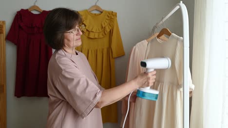 Dressmaker-steaming-dress-on-rail