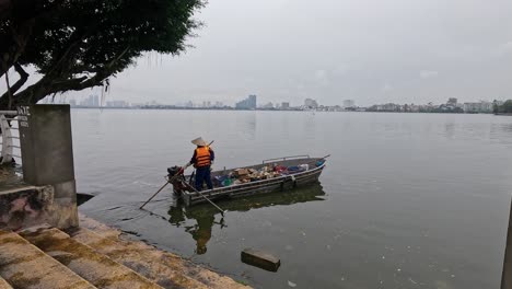 volunteers collect litter from a boat in river