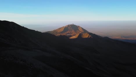 aerial of the beautiful pico de orizaba volcano with a view of the large millimeter telescope