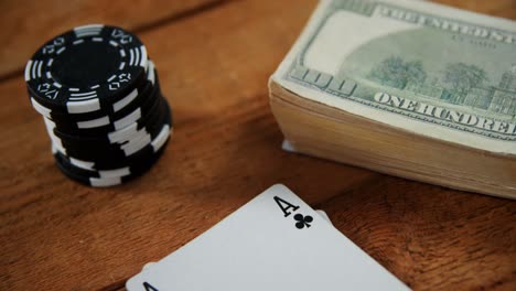 Close-up-of-playing-cards,-dollar-and-casino-chips-on-poker-table-4k