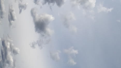 grey cumulus clouds flying at the horizon. dramatic rainy sky from low angle view. timelapse. vertical screen.