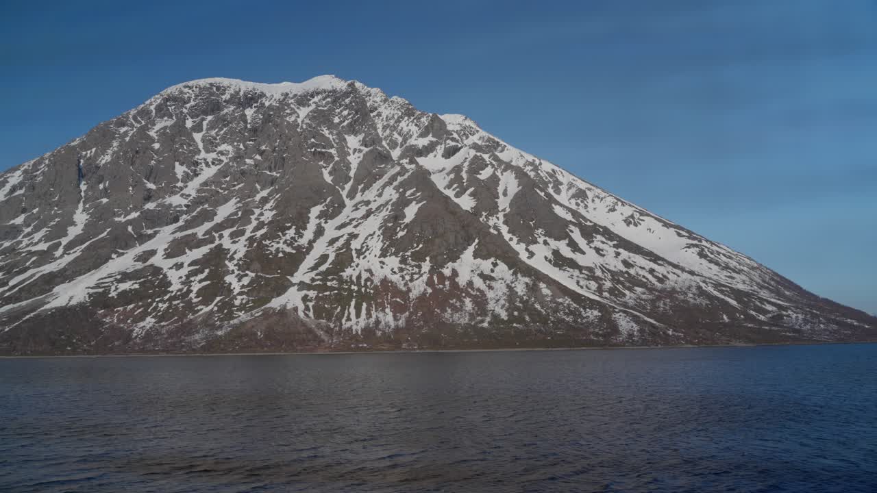 A snow-capped mountain in the Norwegian summer