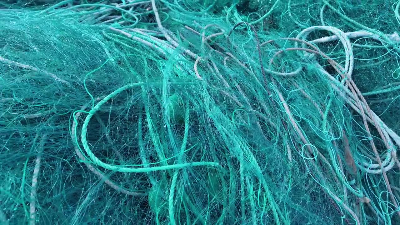 Fishing Nets in Harbour with Boats and Ocean Plastic Pollution