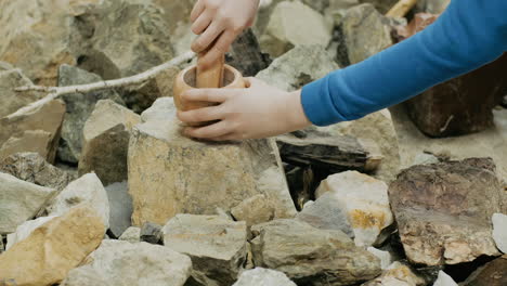 child interacting with ancient stone tools