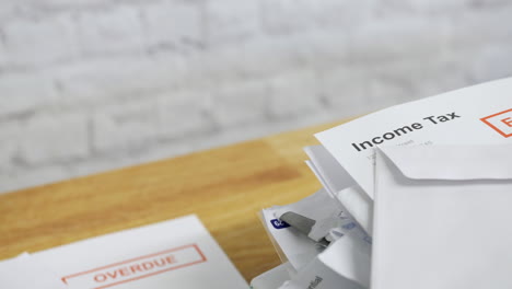 close up of a pile of bills and letters with an income tax bill final notice