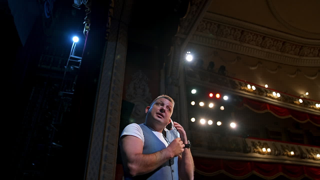 Actor in medical mask on theatre scene. Motivational Speaker.