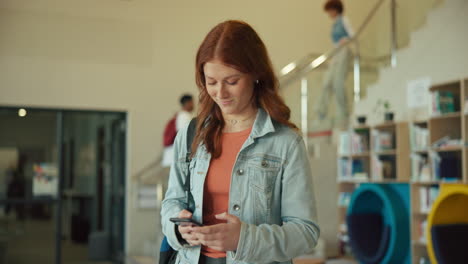 teenage girl using phone in library