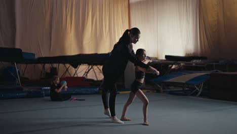 young gymnast training with coach