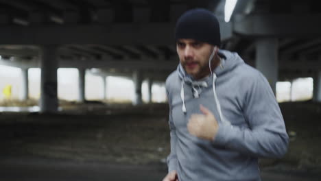 man running under an overpass