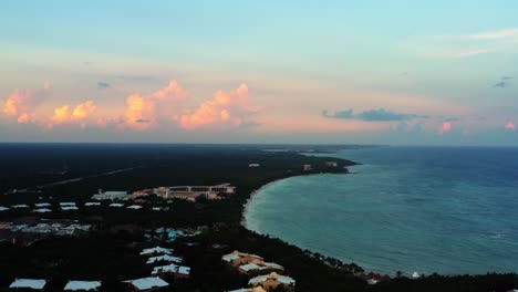 stunning aerial drone time-lapse of a tropical mexican coastline line full of vacation resorts in riviera maya between tulum and cancun during a warm summer sunset