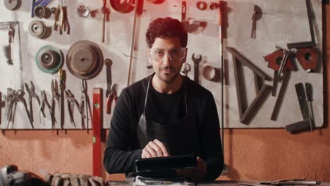 craftsman in a workshop using a tablet