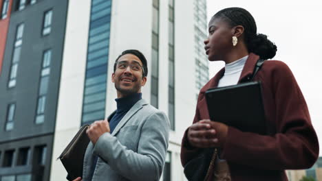 two business professionals having a conversation in the city.