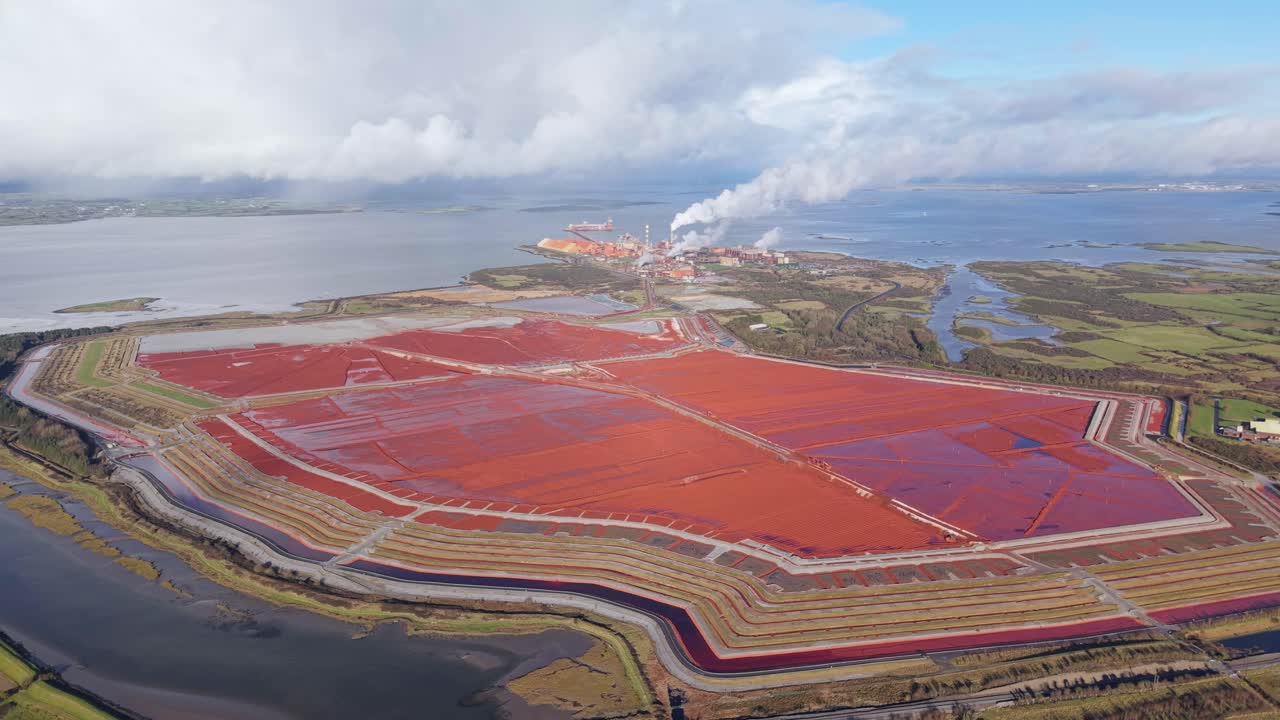 Aughinish alumina refinery in limerick, ireland, with red sludge ponds , aerial view