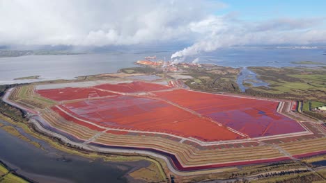aughinish alumina refinery in limerick, ireland, with red sludge ponds , aerial view