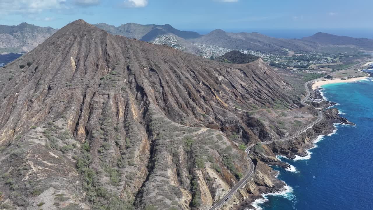 Aerial drone footage flying over Koko Head volcanic crater on Oahu, Hawaii, showcasing rugged cliffs, tropical landscapes, panoramic ocean views, and the island’s dramatic volcanic terrain