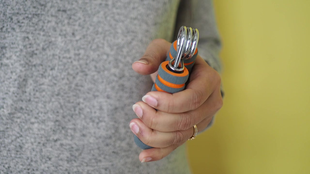 Person Exercising Hand and Forearm with Grip Strengthener