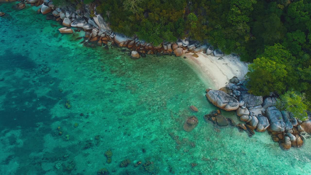 Tropical Perhentian Islands in Malaysia, beautiful aerial drone cinemagraph / seamless video loop in 4K UHD. Clear blue water moving gently in waves, white sandy beaches and palm trees. Perfect place for island adventures and honeymoon.