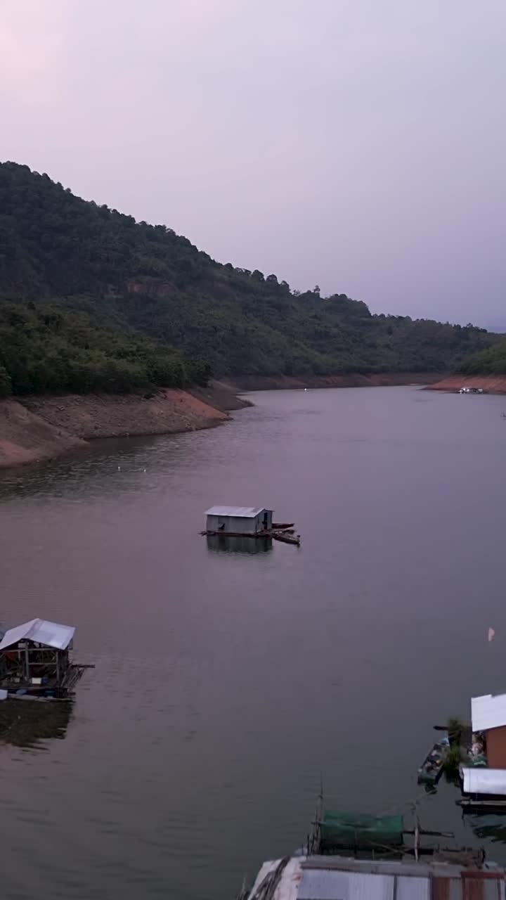 Houses on a lake with a mountain backdrop