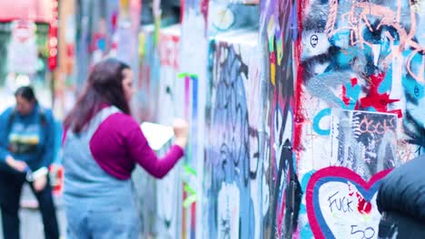 artist painting graffiti on melbourne's iconic wall