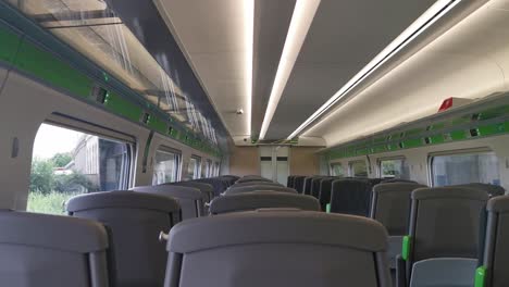 a view of an empty uk train travelling with a view from within a train carriage