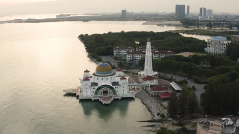 aerial drone establishing b-roll footage of melaka straits floating mosque during sunset