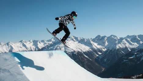 snowboarder performing a jump in the mountains