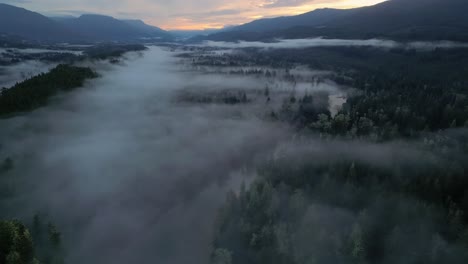 Aerial-view-of-Secluded-Scenic-Lake-and-Foggy-Trees-at-Sunrise