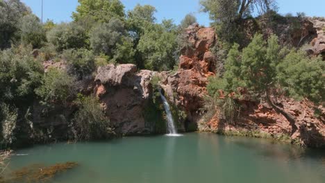 beautiful cascading waterfall, cascata do pego do inferno, algarve portugal, drone dolly