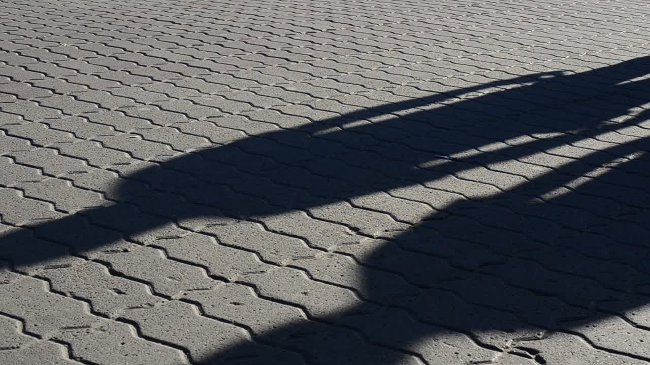Light and shade, reflection of people in beams of the setting sun. People and shadows from them