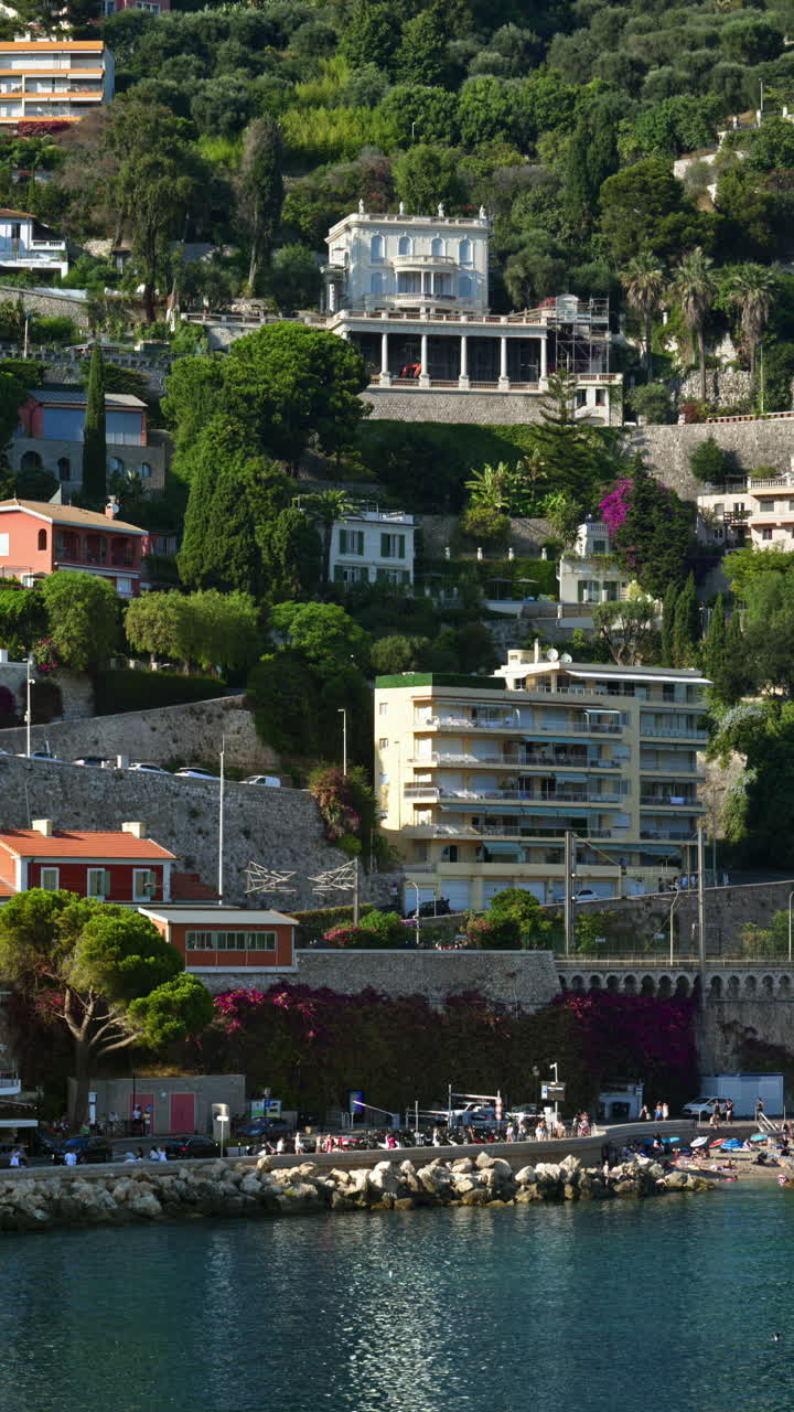 View of the beach with the buildings in Villefranche sur Mer, France on the background. Vertical